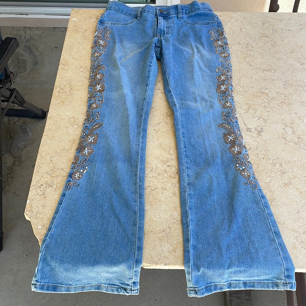 Venus light wash blue jeans with side detailing, flare like.